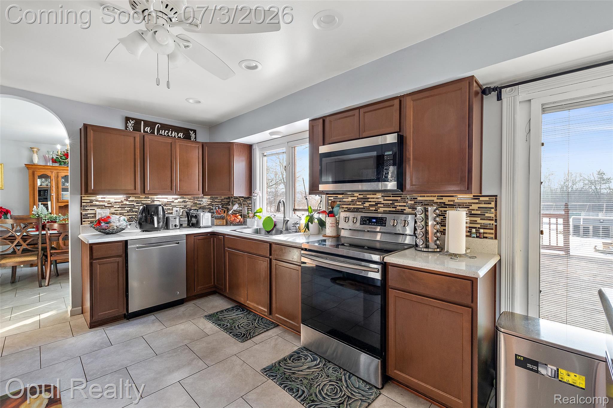 8855 Gross Road Dexter, MI 48130 - Photo 26 of 53 Kitchen featuring wood cabinetry, stainless steel appliances, and a mosaic tile backsplash