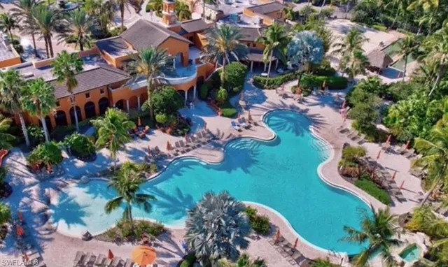 an aerial view of a house with yard swimming pool and outdoor seating