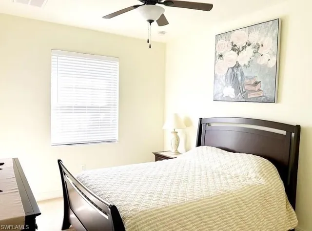 a bedroom with a bed and a painting on the wall