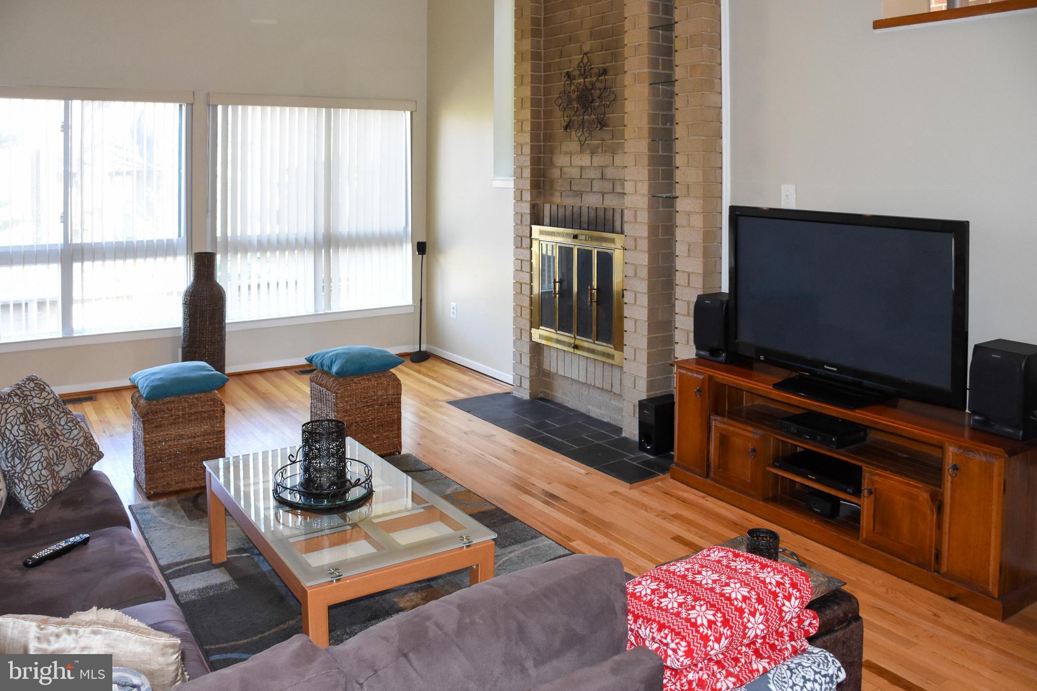 11768 Indian Ridge Road Reston, VA 20191 - Photo 11 of 57 a living room with furniture and a flat screen tv