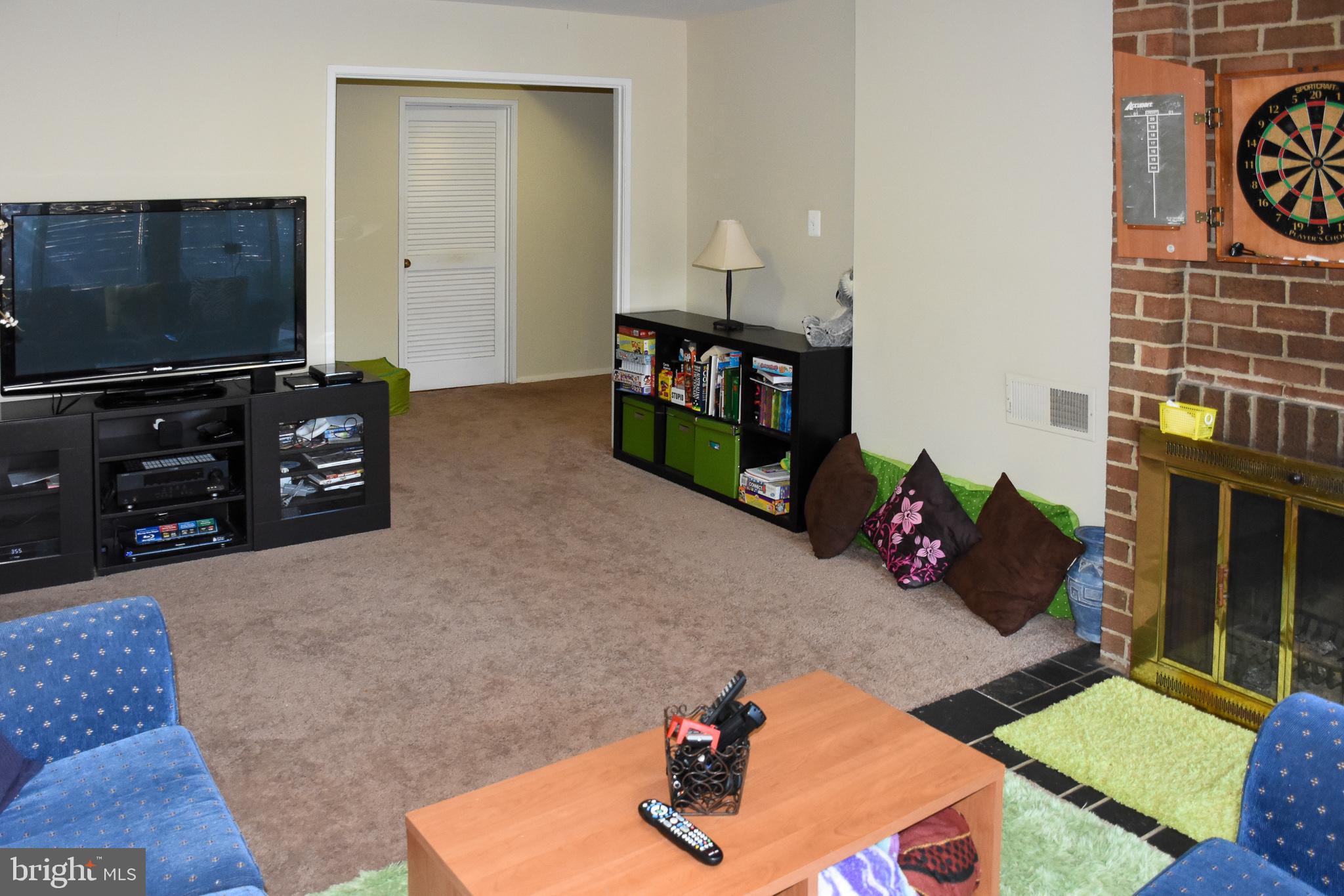 11768 Indian Ridge Road Reston, VA 20191 - Photo 20 of 57 a living room with furniture and a flat screen tv
