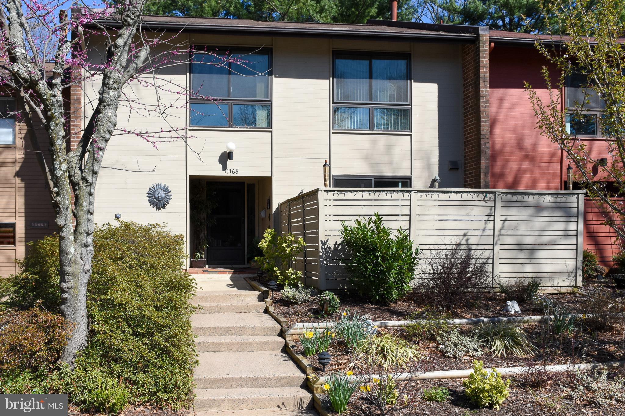 11768 Indian Ridge Road Reston, VA 20191 - Photo 2 of 57 a front view of a house with a garden
