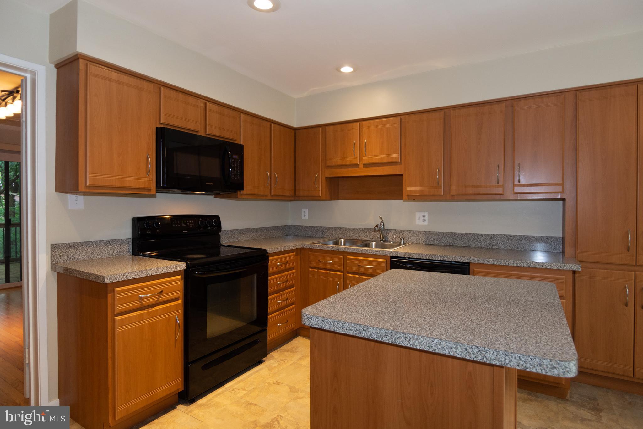 11768 Indian Ridge Road Reston, VA 20191 - Photo 26 of 57 a kitchen with a sink a stove top oven and cabinetry