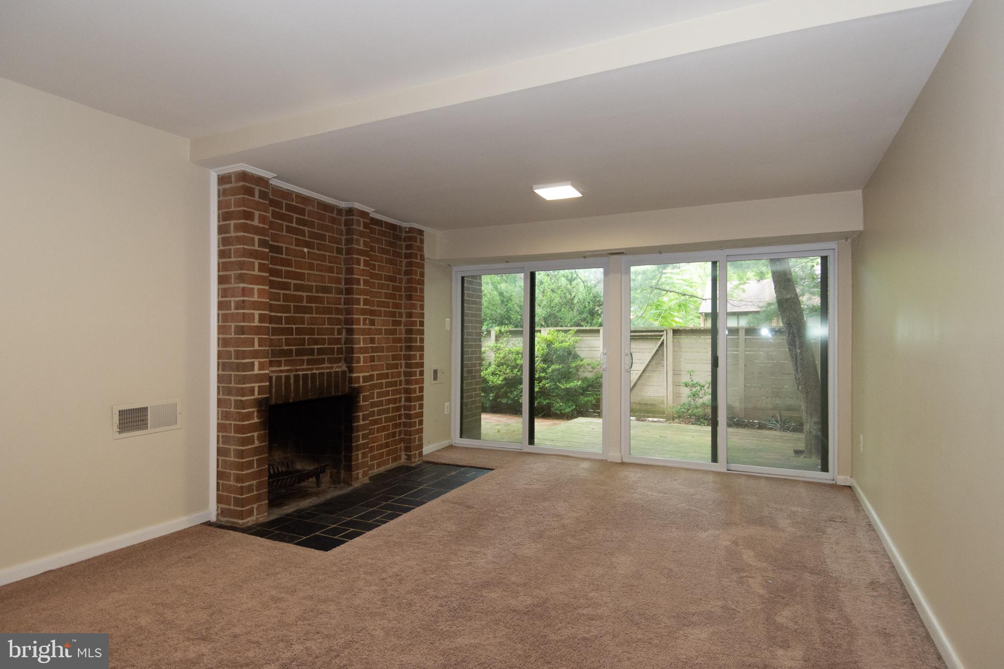 11768 Indian Ridge Road Reston, VA 20191 - Photo 30 of 57 a view of empty room with floor to ceiling window and fireplace