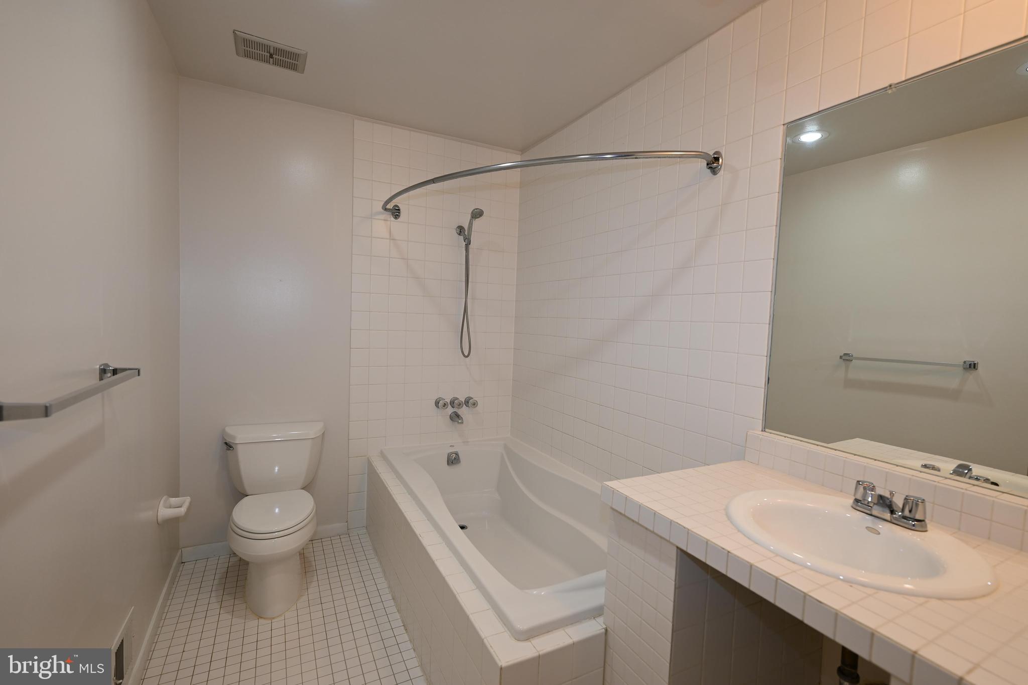 11768 Indian Ridge Road Reston, VA 20191 - Photo 43 of 57 a bathroom with a sink a toilet and shower