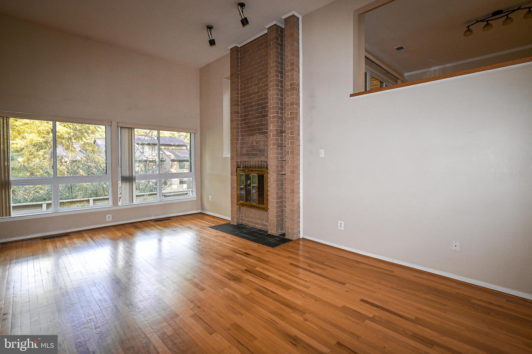 11768 Indian Ridge Road Reston, VA 20191 - Photo 50 of 57 a view of an empty room with wooden floor and a window