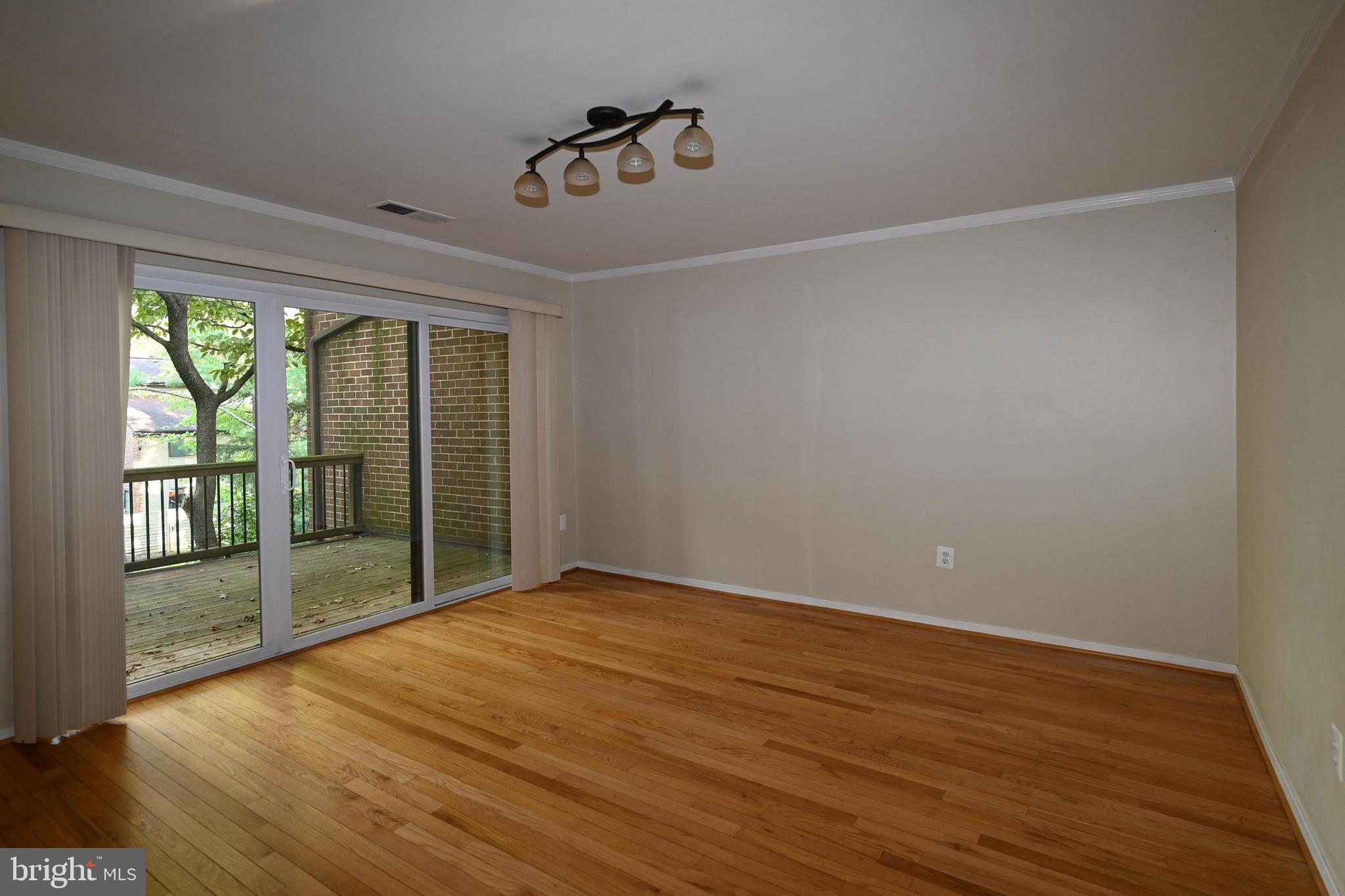 11768 Indian Ridge Road Reston, VA 20191 - Photo 52 of 57 a view of an empty room with wooden floor and a window