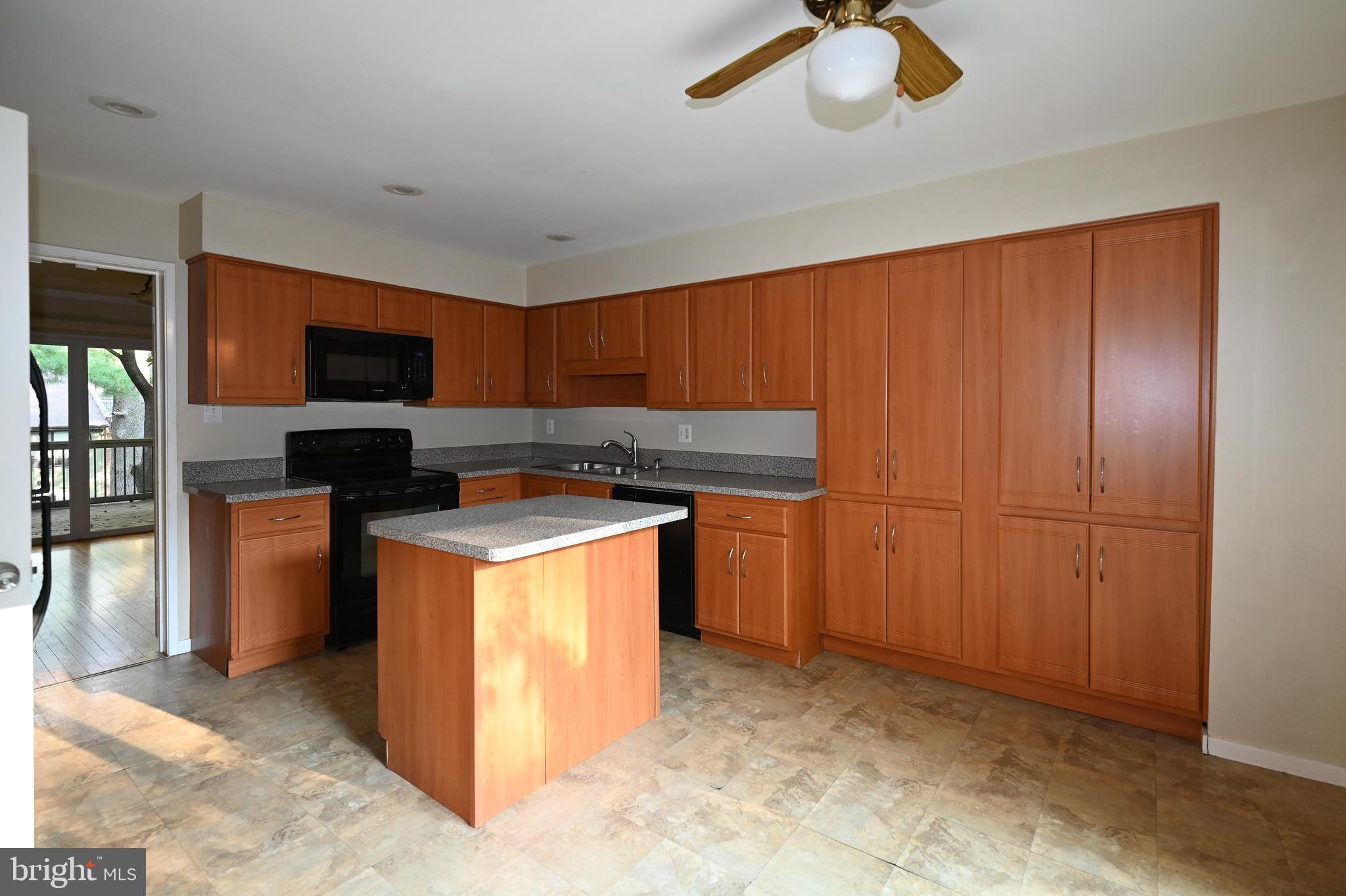 11768 Indian Ridge Road Reston, VA 20191 - Photo 54 of 57 a kitchen with stainless steel appliances granite countertop a stove top oven a sink a counter top space and cabinets