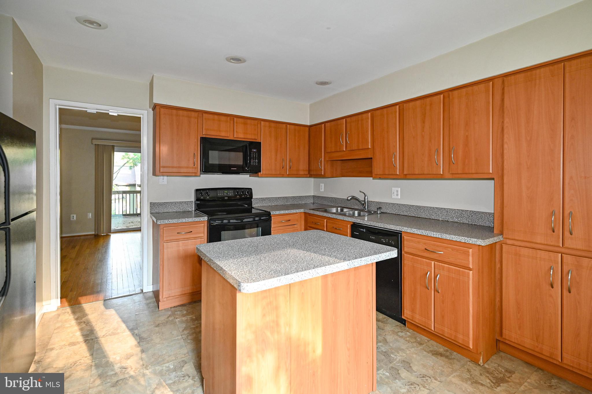 11768 Indian Ridge Road Reston, VA 20191 - Photo 57 of 57 a kitchen with stainless steel appliances granite countertop a stove a sink and a refrigerator