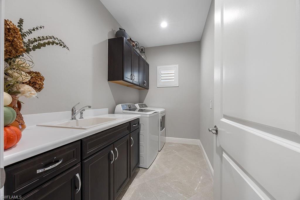 4584 Centaurus Circle Naples, FL 34120 - Photo 12 of 40 Laundry area with cabinet space, washing machine and clothes dryer, and recessed lighting