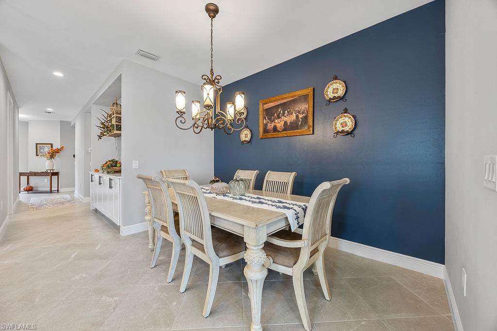 4584 Centaurus Circle Naples, FL 34120 - Photo 19 of 40 Dining space featuring a chandelier, recessed lighting, and light tile patterned floors