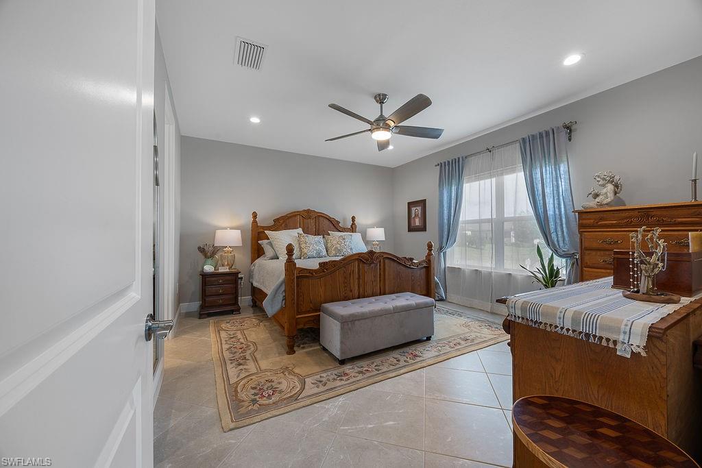 4584 Centaurus Circle Naples, FL 34120 - Photo 22 of 40 Bedroom with recessed lighting, light tile patterned floors, and ceiling fan
