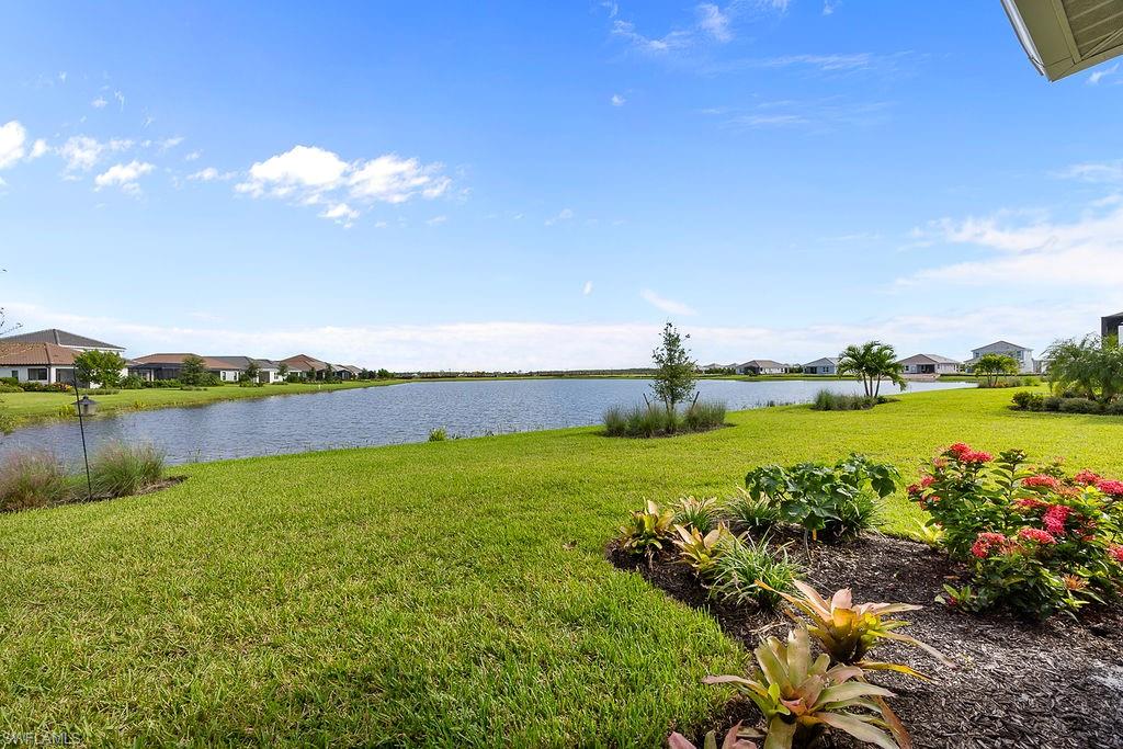 4584 Centaurus Circle Naples, FL 34120 - Photo 29 of 40 View of grassy yard with a water view and a residential view