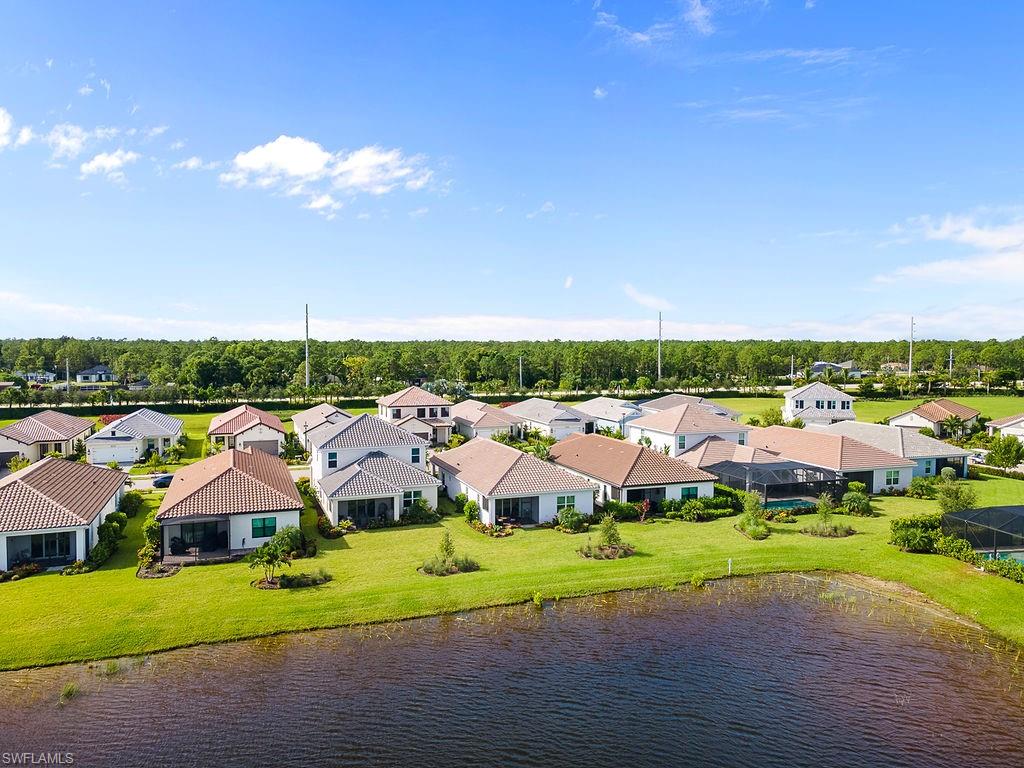 4584 Centaurus Circle Naples, FL 34120 - Photo 34 of 40 Aerial perspective of suburban area with a nearby body of water and a tree filled landscape