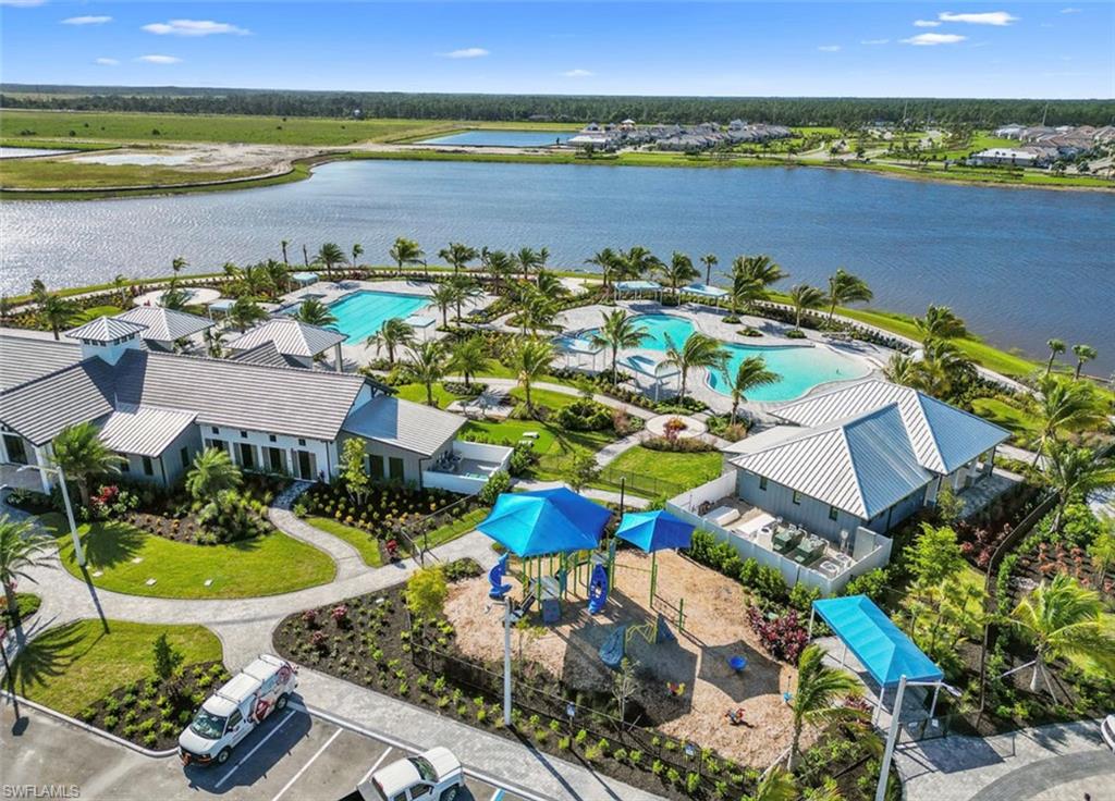 4584 Centaurus Circle Naples, FL 34120 - Photo 37 of 40 Drone / aerial view of a pool area and a nearby body of water
