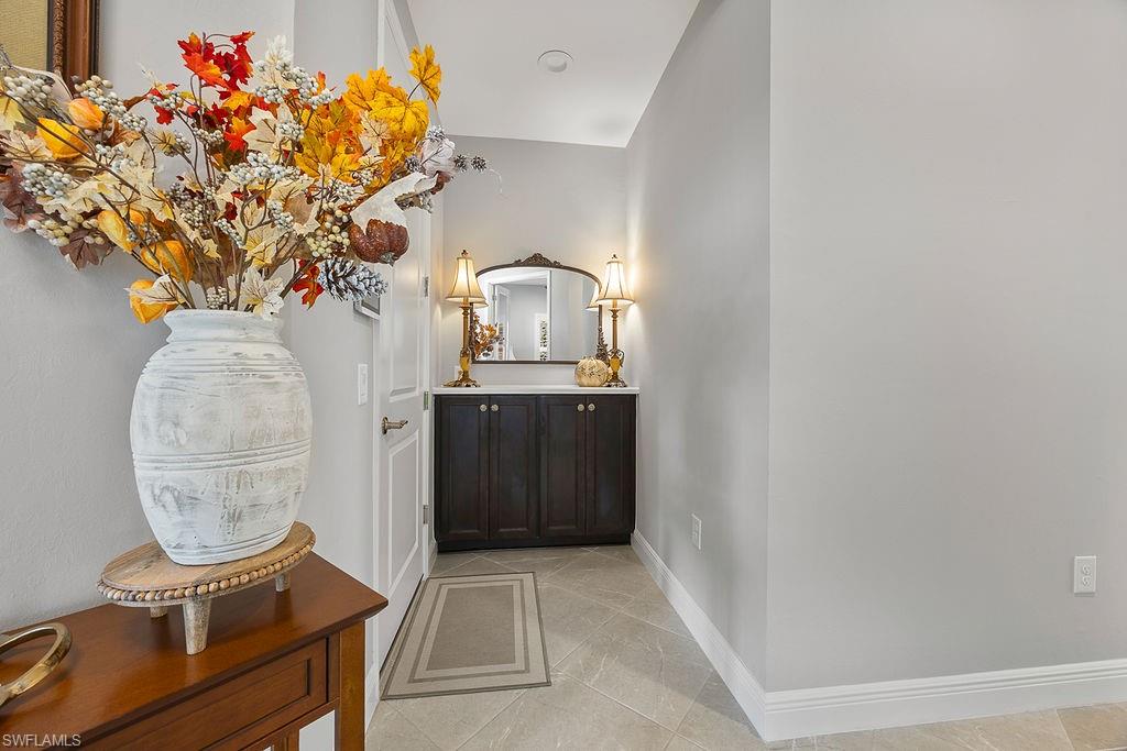 4584 Centaurus Circle Naples, FL 34120 - Photo 5 of 40 Bathroom featuring light tile patterned flooring and vanity