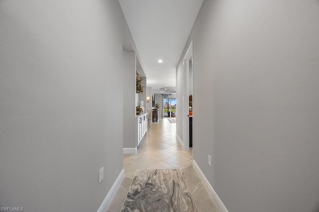 4584 Centaurus Circle Naples, FL 34120 - Photo 6 of 40 Hallway featuring light tile patterned flooring and recessed lighting