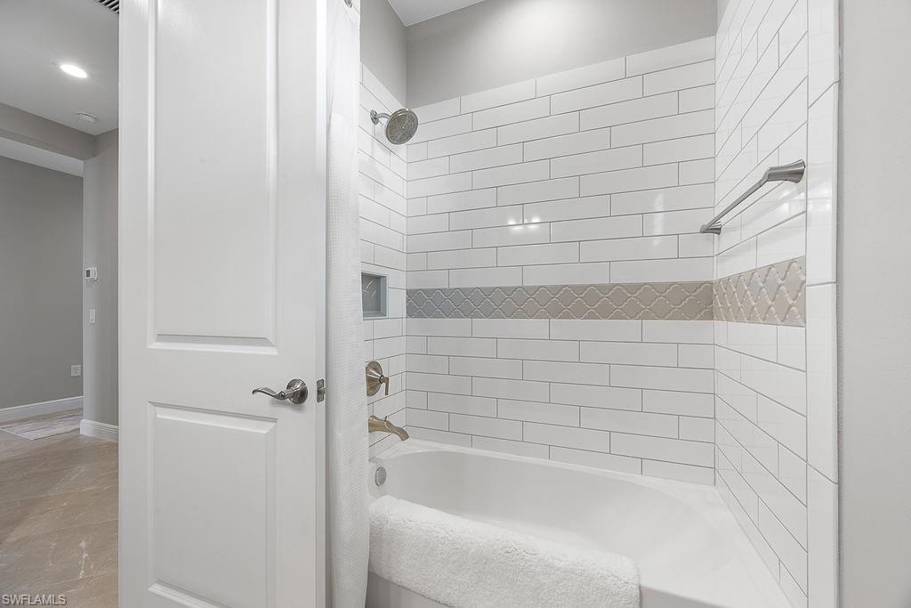4584 Centaurus Circle Naples, FL 34120 - Photo 8 of 40 Full bath with shower / bathtub combination and baseboards