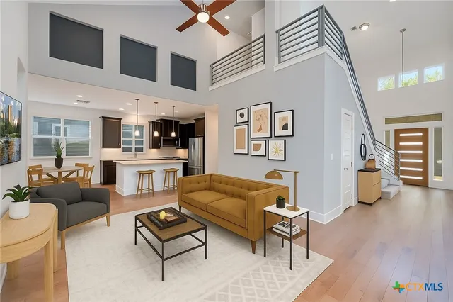 a living room with furniture and wooden floor