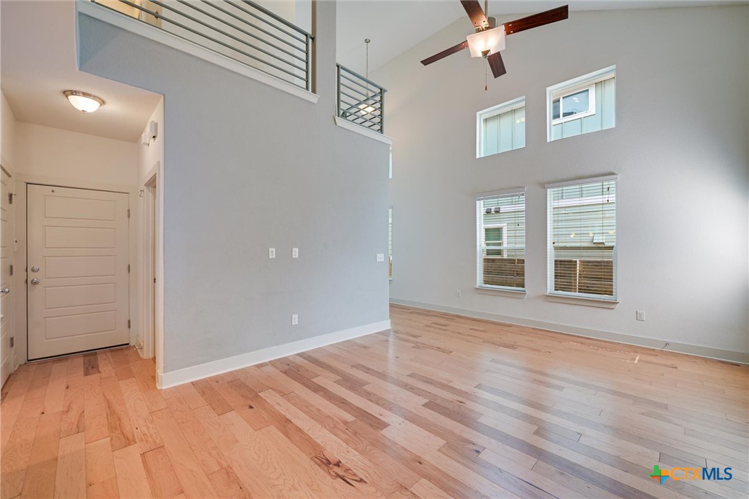 2205 Capulet Street Austin, TX 78741 - Photo 11 of 22 a view of an empty room with wooden floor and a window