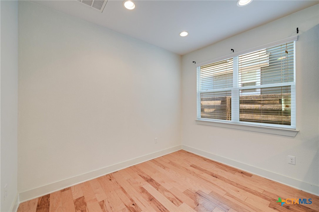 2205 Capulet Street Austin, TX 78741 - Photo 15 of 22 a view of empty room with wooden floor and fan