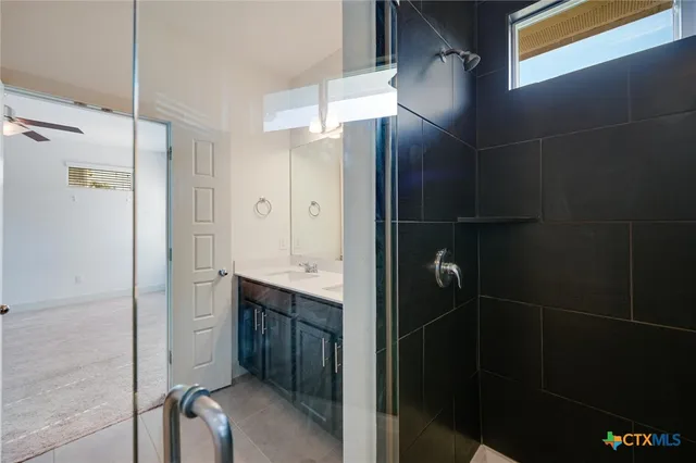 a bathroom with a shower and a sink