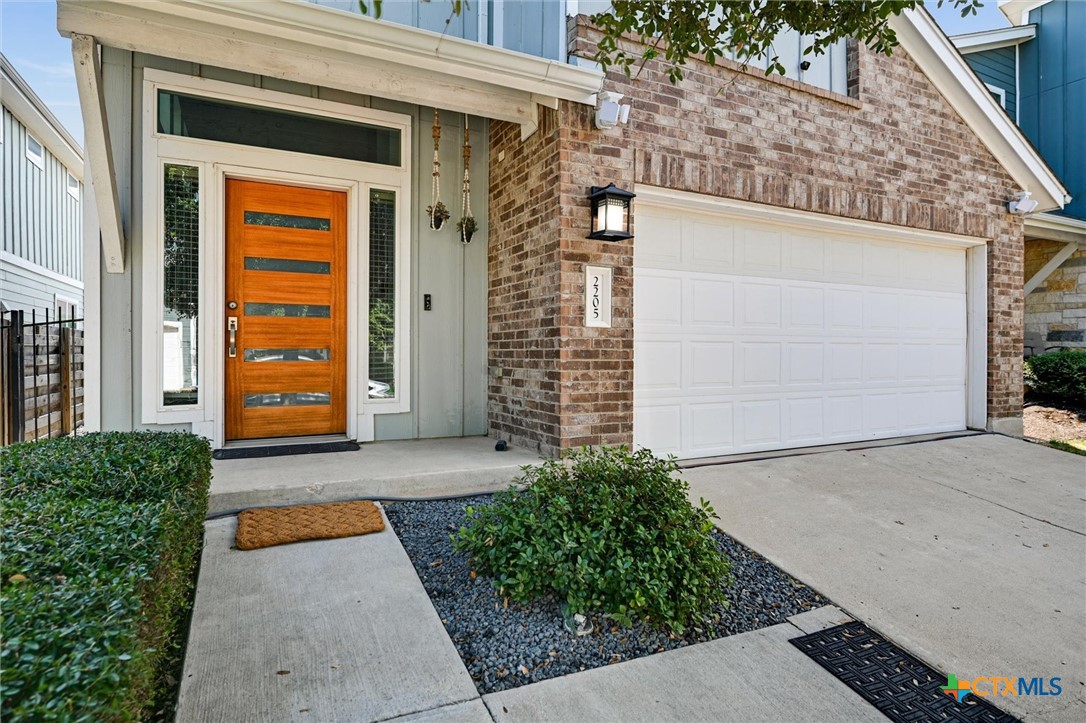 2205 Capulet Street Austin, TX 78741 - Photo 2 of 22 a front view of a house with a garage