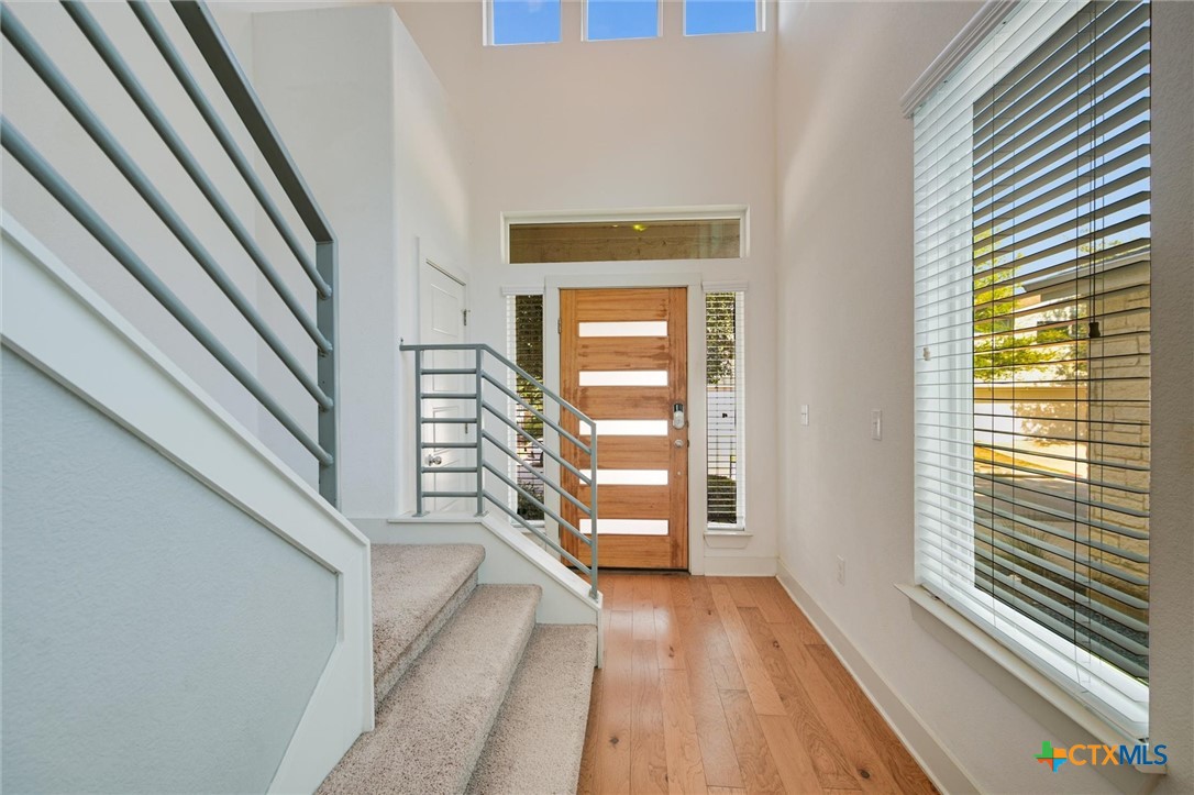 2205 Capulet Street Austin, TX 78741 - Photo 6 of 22 a view of a hallway with wooden floor and staircase