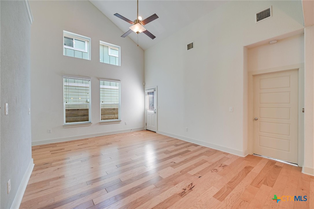 2205 Capulet Street Austin, TX 78741 - Photo 10 of 22 a view of an empty room with a window and wooden floor