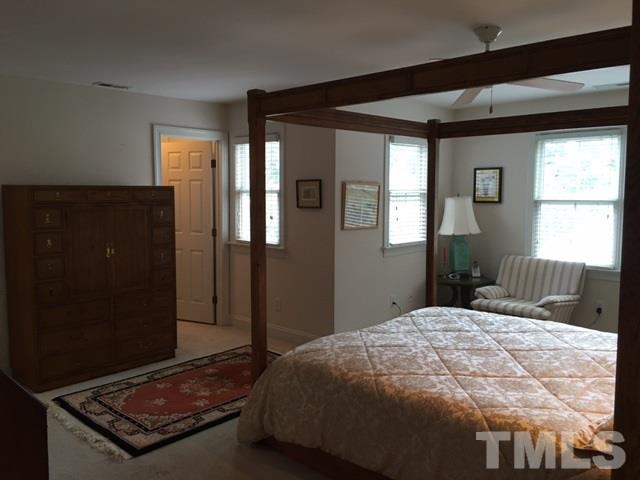 9101 Carrington Ridge Drive Raleigh, NC 27615 - Photo 11 of 14 a bedroom with a bed and window