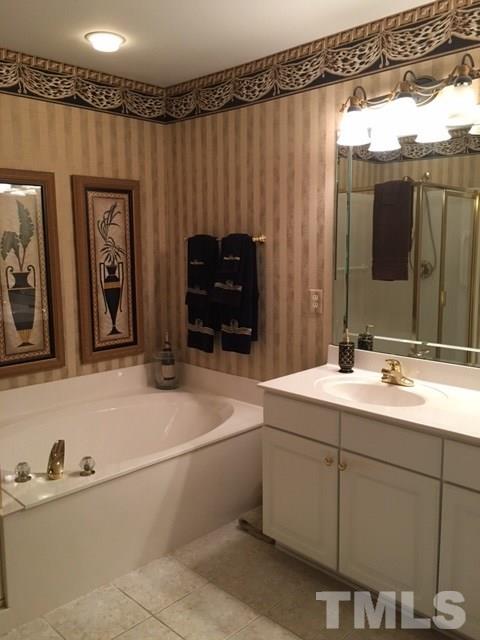 9101 Carrington Ridge Drive Raleigh, NC 27615 - Photo 12 of 14 a bathroom with a sink and a mirror
