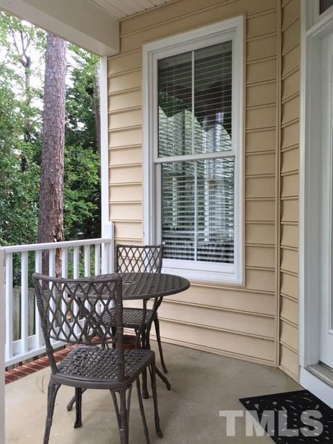 9101 Carrington Ridge Drive Raleigh, NC 27615 - Photo 13 of 14 a view of a wooden chairs and table in the balcony