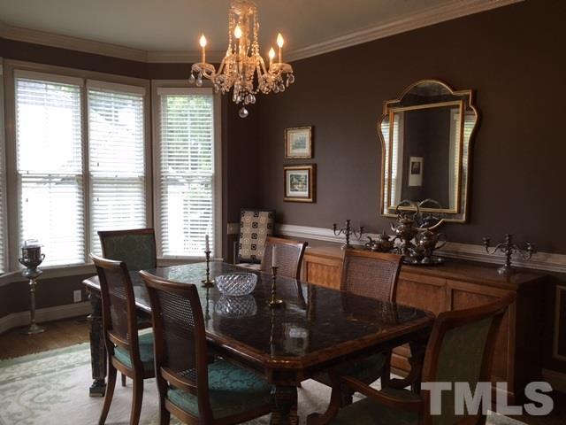 9101 Carrington Ridge Drive Raleigh, NC 27615 - Photo 3 of 14 a view of a dining room with furniture and a chandelier