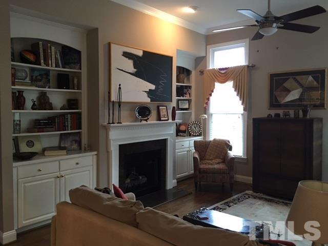 9101 Carrington Ridge Drive Raleigh, NC 27615 - Photo 5 of 14 a living room with furniture a flat screen tv and a fireplace