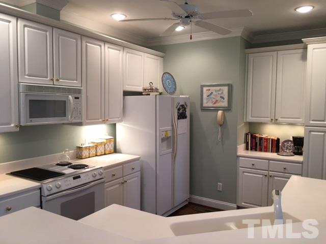 9101 Carrington Ridge Drive Raleigh, NC 27615 - Photo 6 of 14 a kitchen with stainless steel appliances granite countertop a refrigerator stove and sink