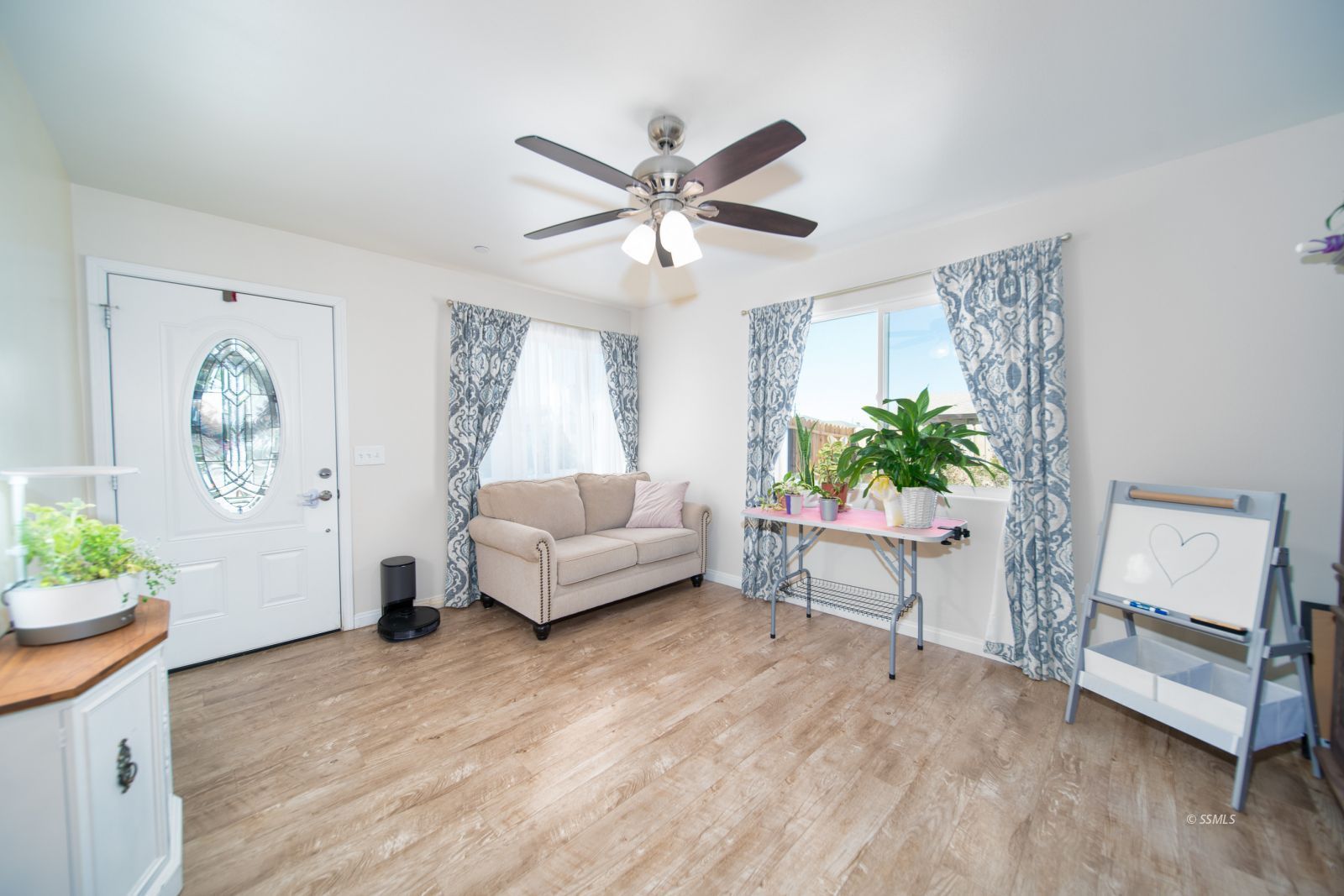 1540 Mayo Street Ridgecrest, CA 93555 - Photo 5 of 32 a living room with furniture and a potted plant