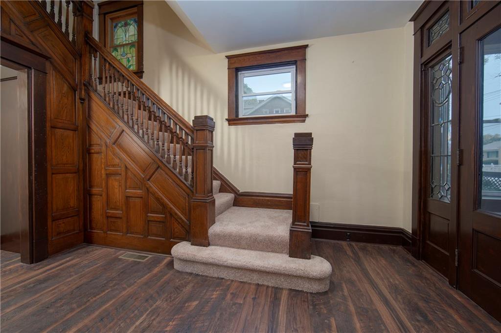 101 Shadyhill Road Pittsburgh, PA 15205 - Photo 4 of 25 Another view from the entry into the formal living room. The grand balustrade gives a view of more beautiful wood and a peek at the stained glass window on the stairway.
