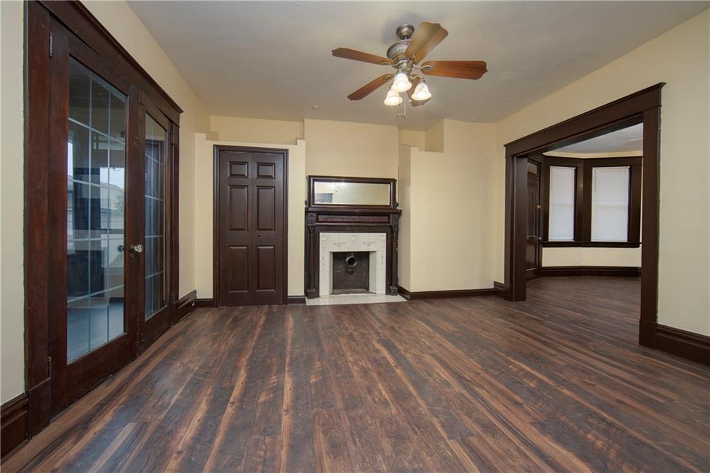 101 Shadyhill Road Pittsburgh, PA 15205 - Photo 5 of 25 LIVING ROOM - An overall view of the formal living room highlighting the grand decorator fireplace and its beautiful floors. The flow from the Entryway through this room and into the Dining Room is accentuated.