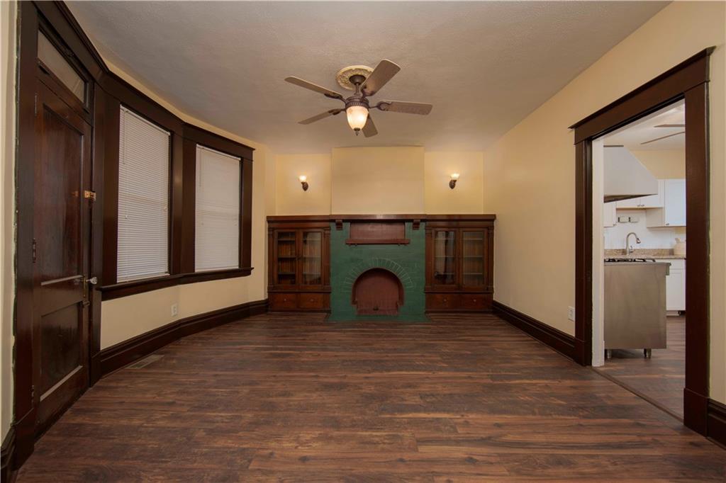 101 Shadyhill Road Pittsburgh, PA 15205 - Photo 7 of 25 DINING ROOM - Features another tiled fireplace flanked on each side with glass built-ins. Wall sconces provide a glow of warmth and an invitation to relax.