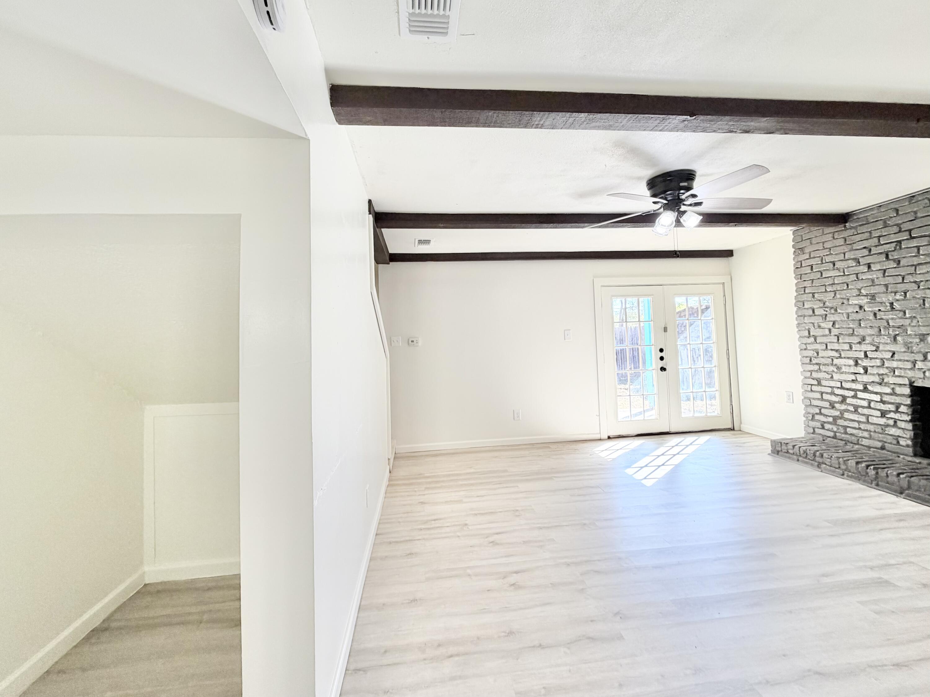 3407 30th Street Lubbock, TX 79410 - Photo 18 of 26 a view of an empty room with wooden floor and a window