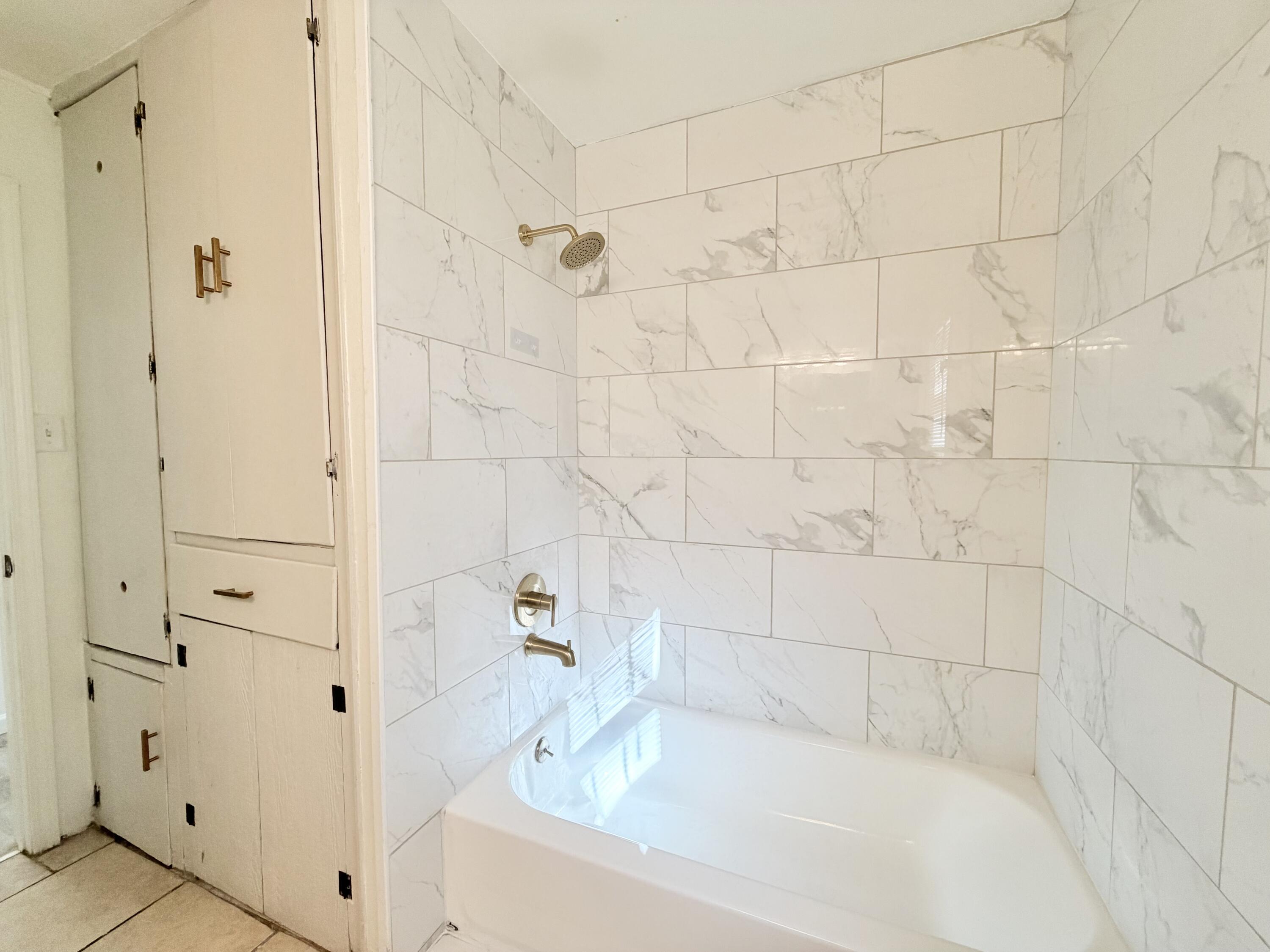 3407 30th Street Lubbock, TX 79410 - Photo 20 of 26 a bathroom with a bathtub