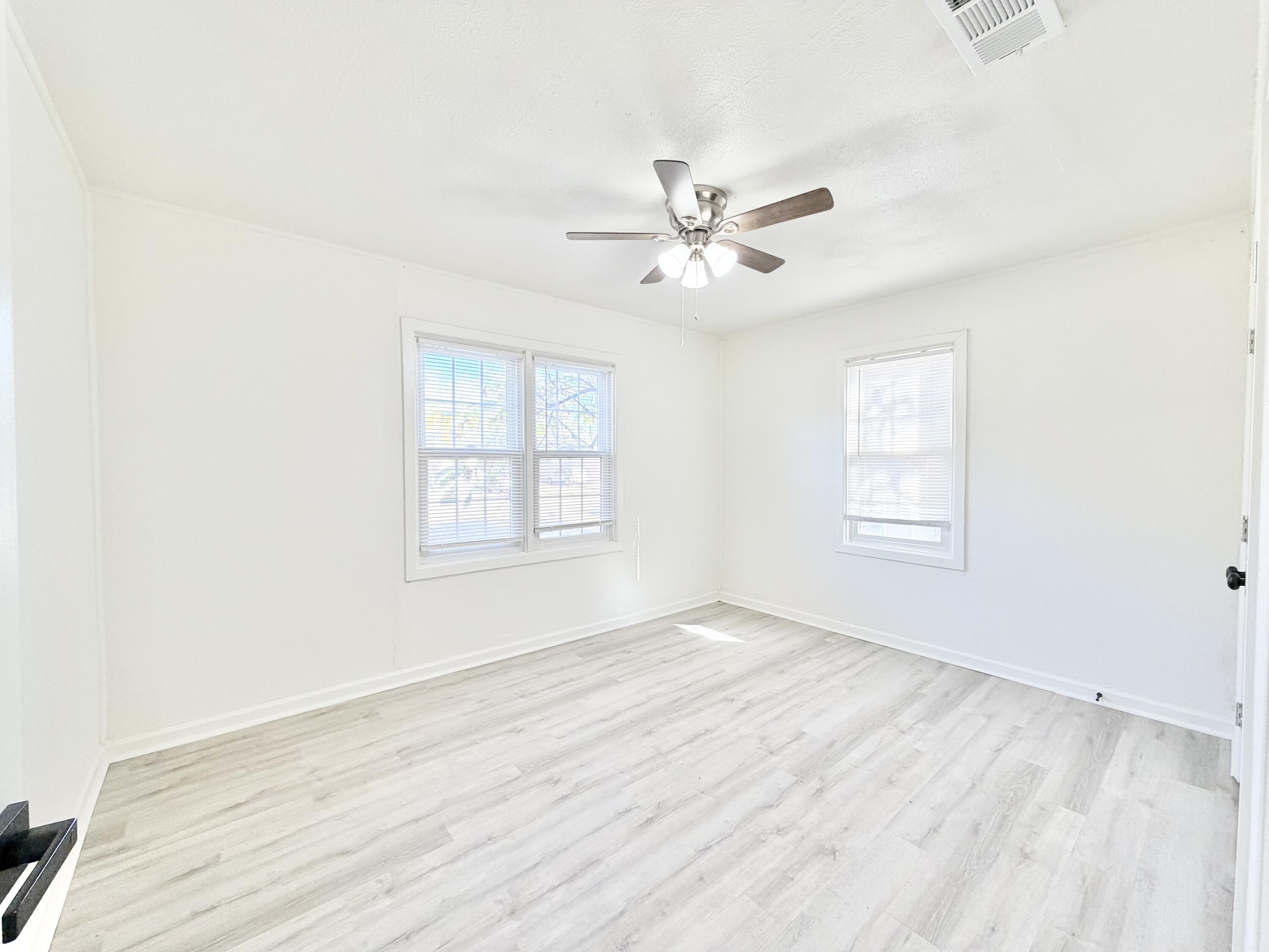 3407 30th Street Lubbock, TX 79410 - Photo 21 of 26 a view of empty room with wooden floor and fan