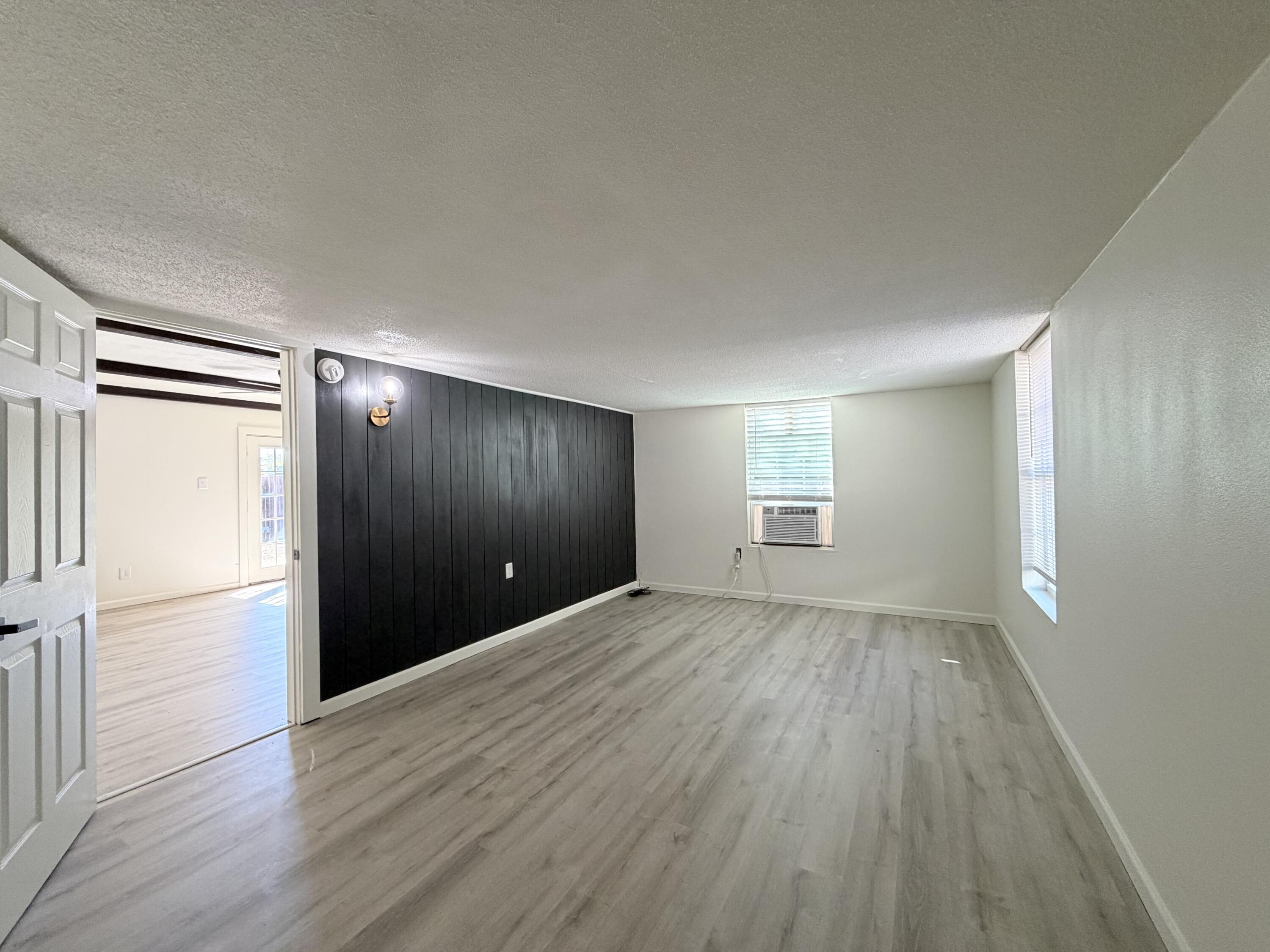 3407 30th Street Lubbock, TX 79410 - Photo 23 of 26 an empty room with wooden floor and windows