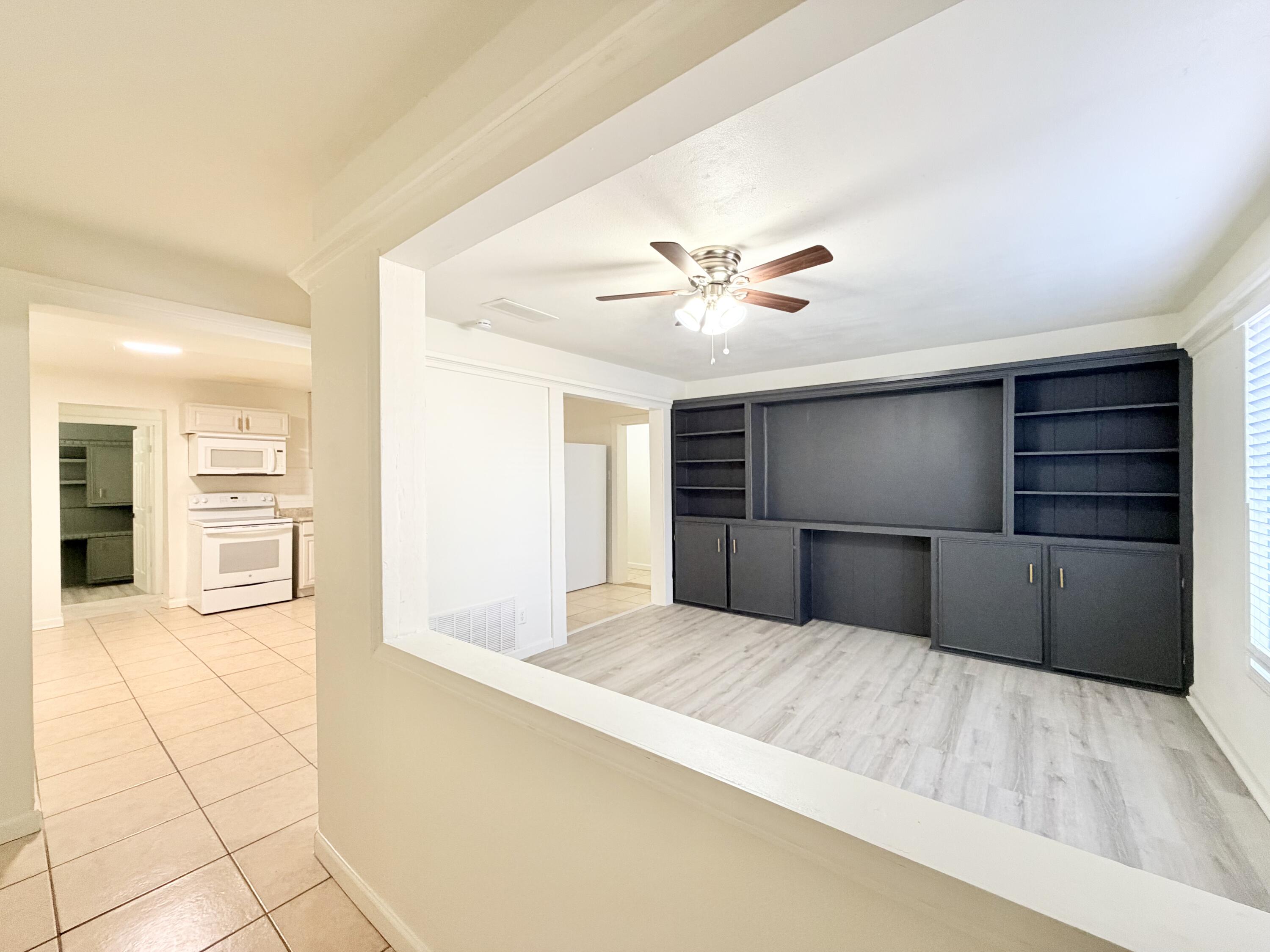 3407 30th Street Lubbock, TX 79410 - Photo 3 of 26 a view of an empty room with cabinet and a kitchen