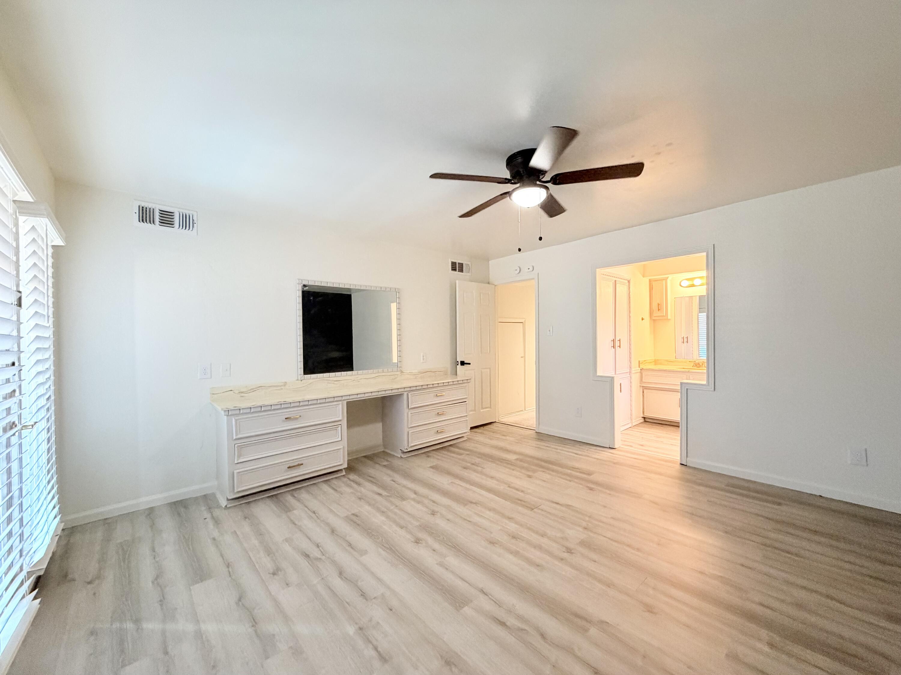 3407 30th Street Lubbock, TX 79410 - Photo 8 of 26 an empty room with wooden floor and windows