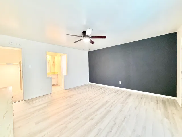 a view of a livingroom with a ceiling fan and window