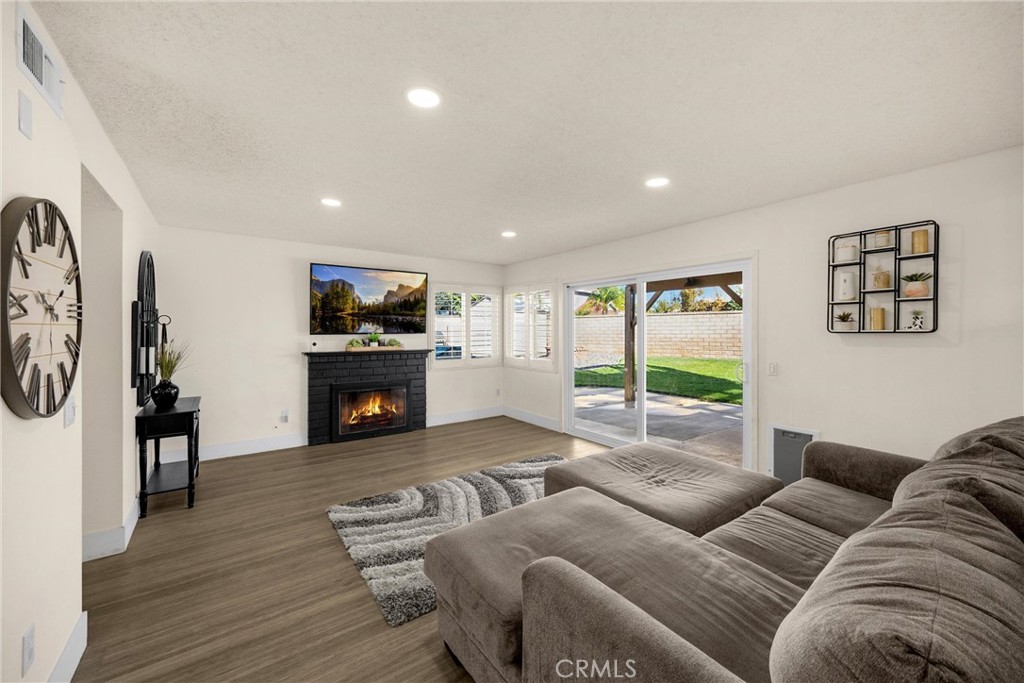 7077 Campbell Place Rancho Cucamonga, CA 91701 - Photo 19 of 74 a living room with furniture and a fireplace