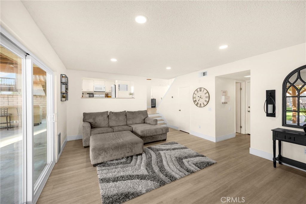 7077 Campbell Place Rancho Cucamonga, CA 91701 - Photo 21 of 74 a living room with furniture and a wooden floor