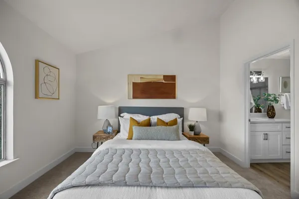 a bedroom with a bed and a potted plant