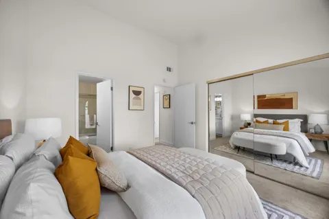 a bedroom with a bed and lamp